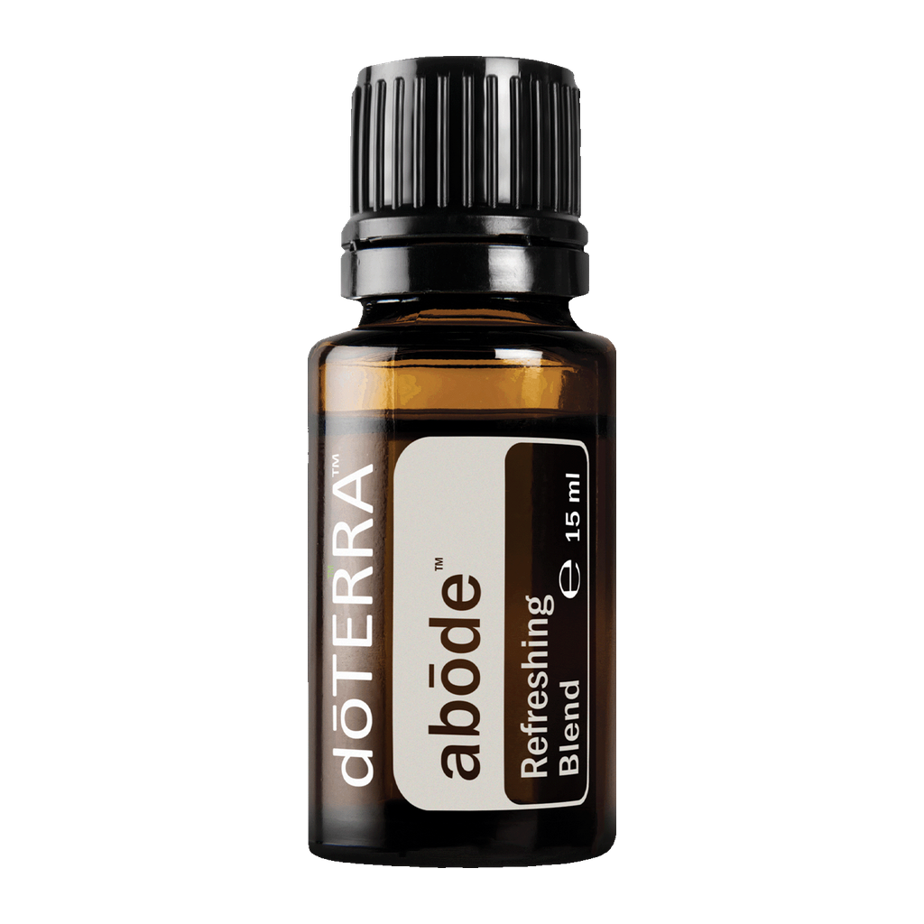 A 15 ml amber glass bottle of doTERRA abóde Refreshing Blend essential oil with a black ribbed cap and a white and brown label, shown on a solid white background.