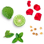 A flat-lay arrangement of green ingredients on a white background, including a textured green fruit, a sliced lime, mint leaves, red rose petals, and small tan seeds.