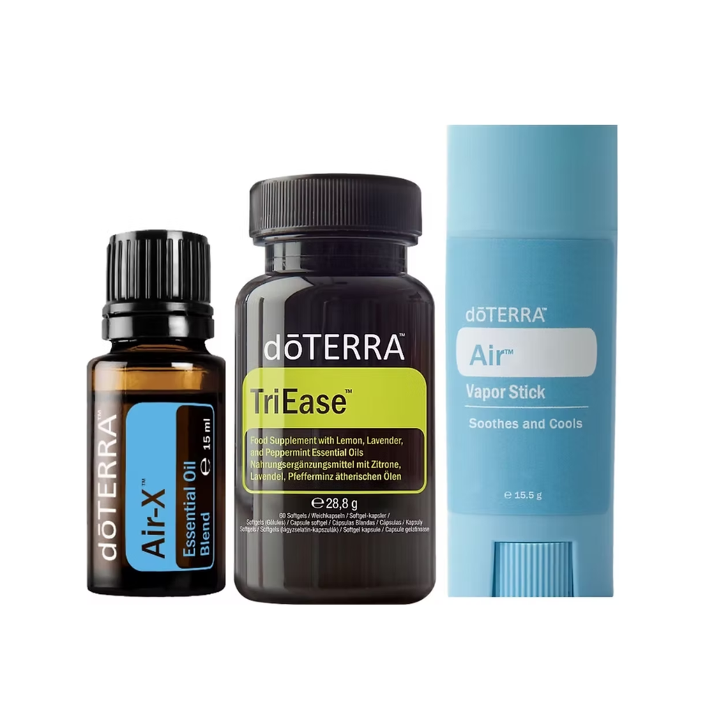Three DoTerra-branded products on a plain white background: a small amber essential oil bottle labeled Air-X, a dark brown supplement bottle labeled TriEase, and a light blue vapor stick package labeled Air.