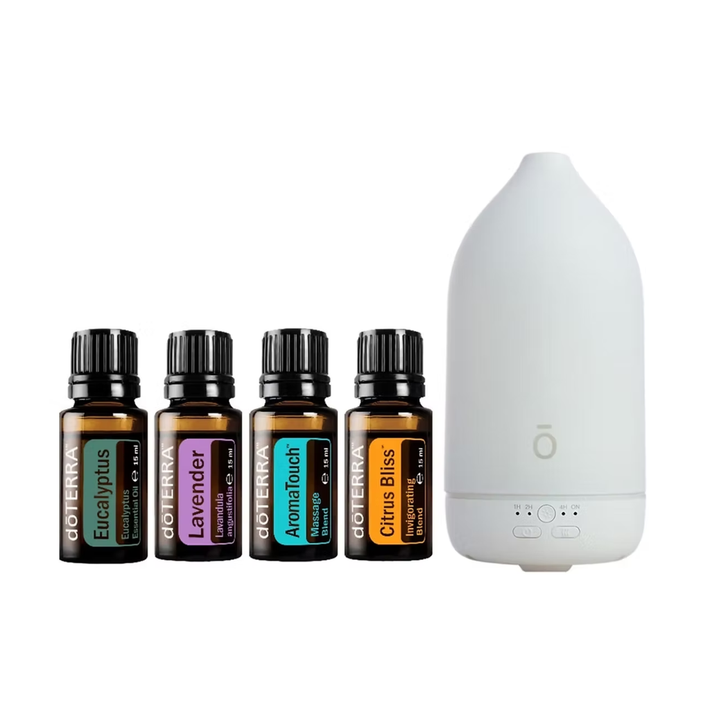 A diffuser and essential oil set on a white background, featuring four amber glass bottles of doTERRA essential oils (Eucalyptus, Lavender, Aromatherapy, Citrus Bliss) and a white electronic diffuser.