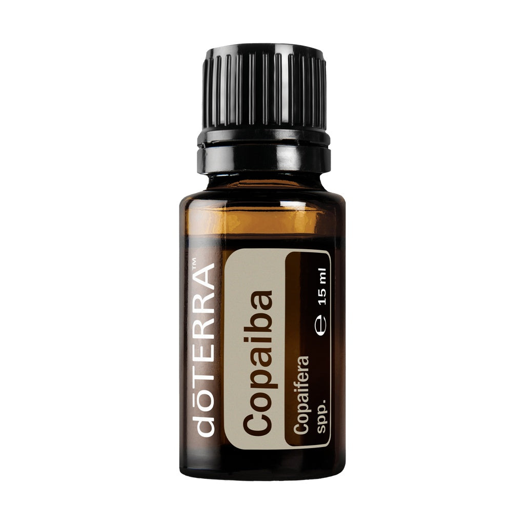 A 15 ml amber glass bottle of döTERRA Copaiba essential oil with a black ribbed cap and a beige and brown label, shown on a solid white background.