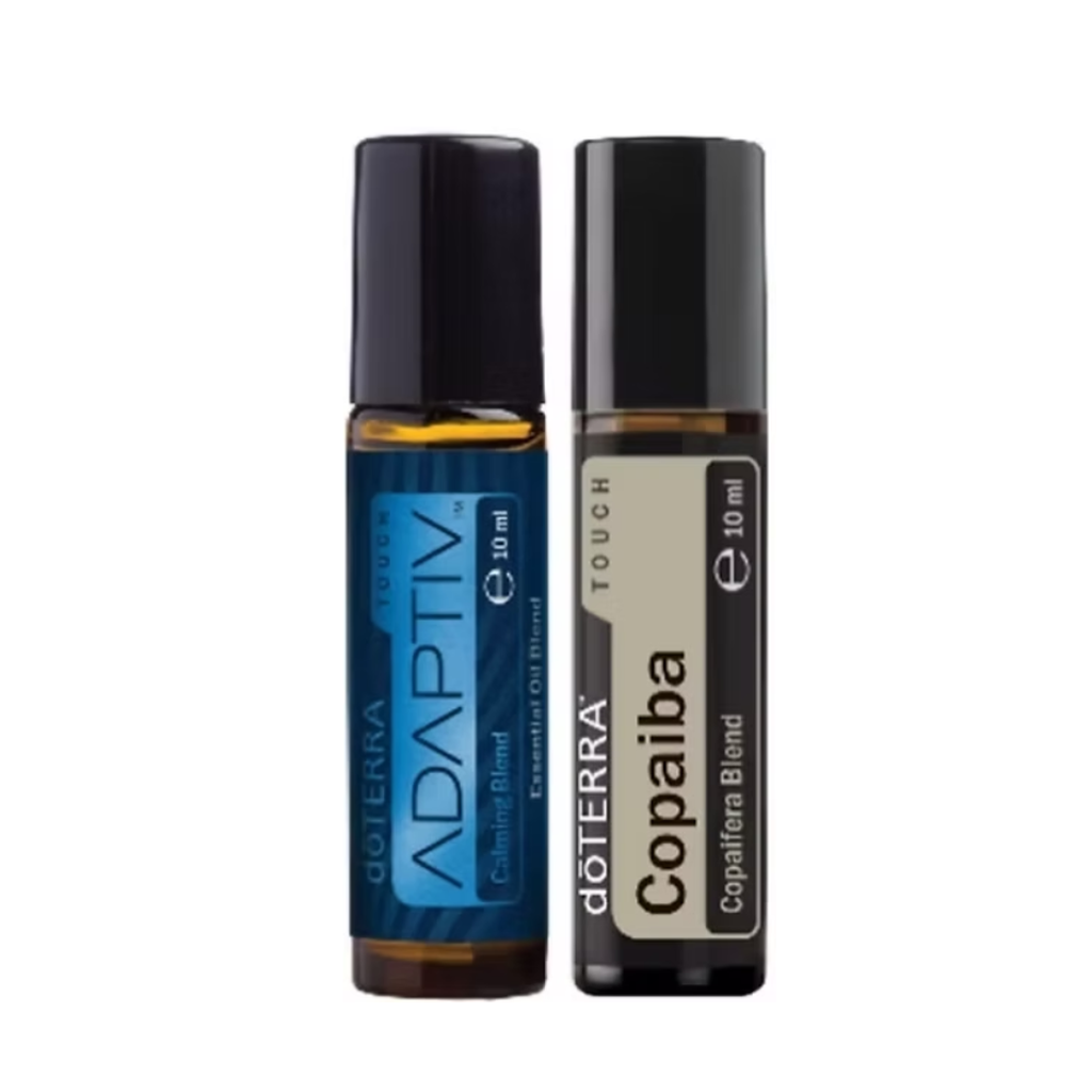Two 10 ml roll-on essential oil bottles from doTERRA, standing side-by-side on a plain white background. The left bottle is the ADAPTIV Chilling Blend with a blue label and black cap.
