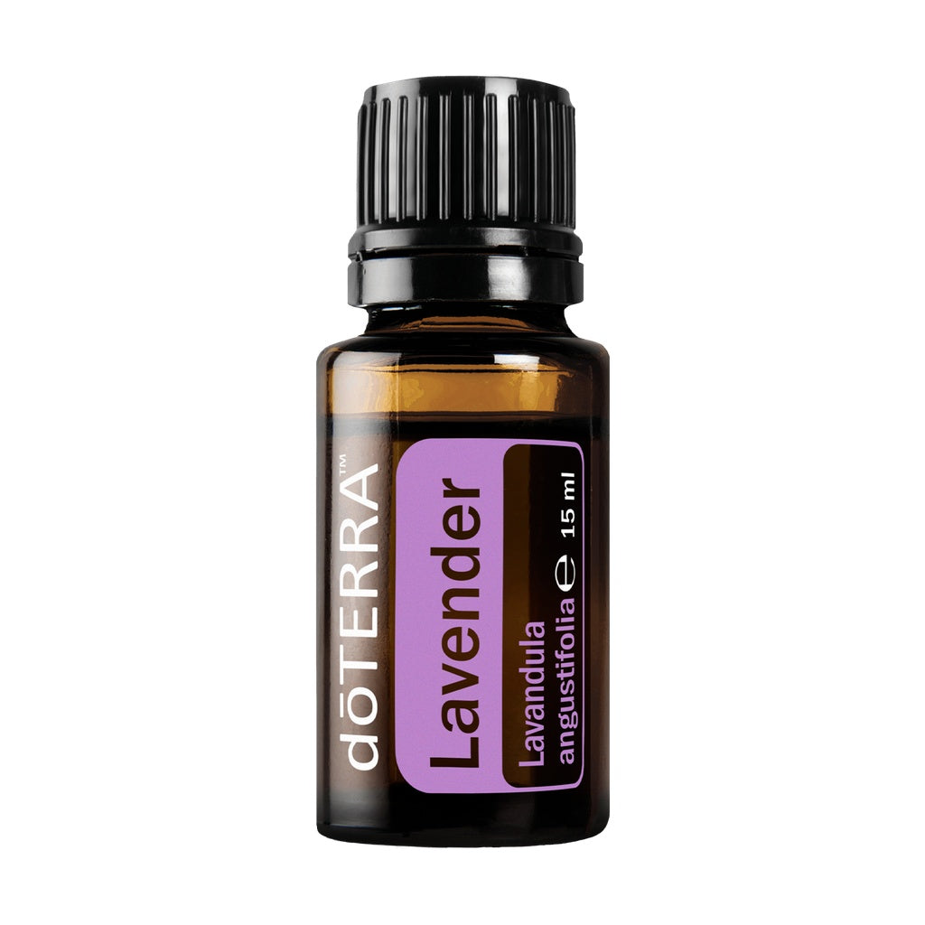 A 15 ml bottle of döTERRA Lavender essential oil on a solid white background. The bottle is made of dark amber glass with a black ribbed cap and features a purple and black label with the brand name 'döTERRA' and 'Lavender' printed on it.