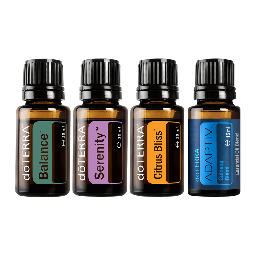 Four amber glass dropper bottles of doTERRA essential oils arranged side by side on a white background: Balance, Serenity, Citrus Bliss, and Calming Blend.