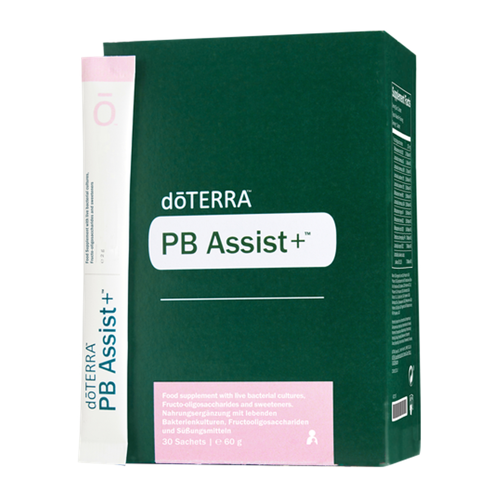 A box of döTERRA PB Assist+ food supplement, featuring a dark green box with a pink label and a single sachet standing beside it on a white background.