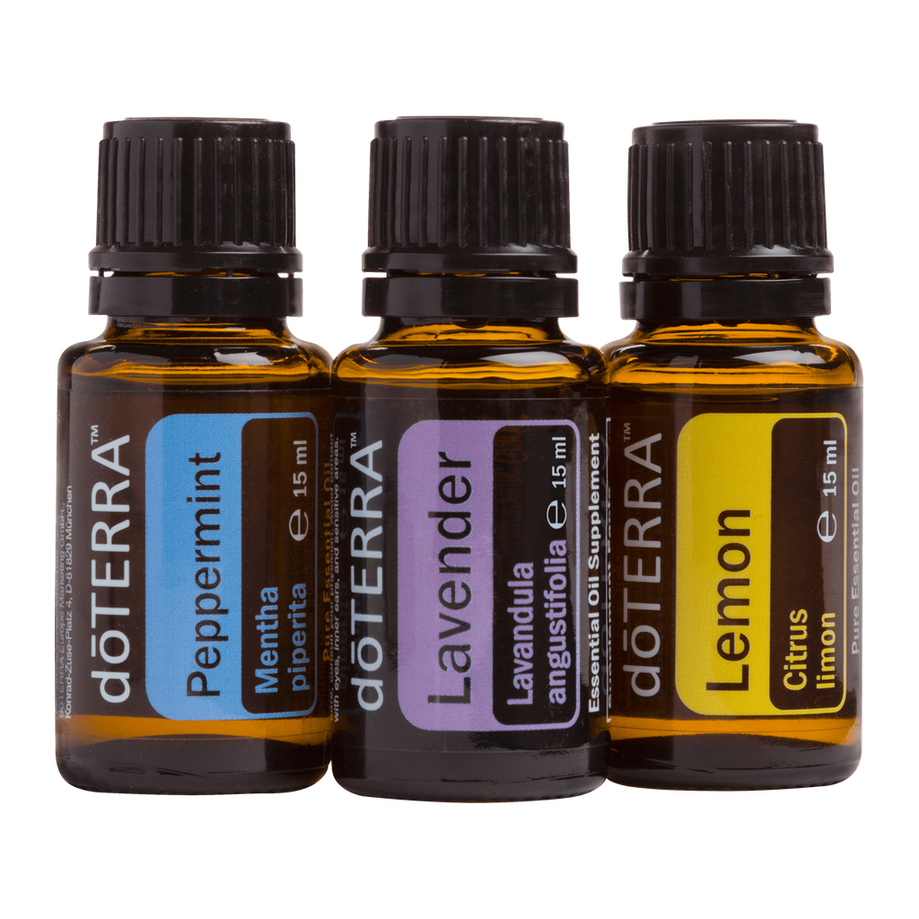 Three amber glass essential oil bottles with black caps from doTERRA, shown side by side on a white background. The labels read Peppermint, Lavender, and Lemon.