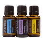 Three amber glass essential oil bottles with black caps from doTERRA, shown side by side on a white background. The labels read Peppermint, Lavender, and Lemon.
